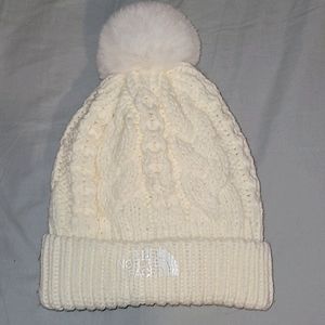 The norths face white beanie with pompom.